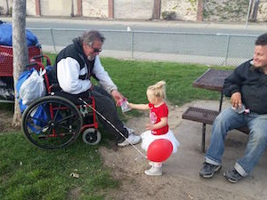 Delaney giving Valentines to homeless men in the park